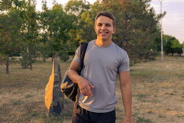 Fototapeta premium Young athletic man walking in the park on a sunny day.