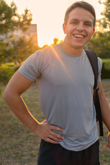 Fototapeta premium Young athletic man walking in the park on a sunny day.