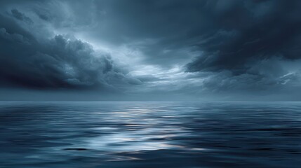 Obraz premium Vast dark blue ocean under a dramatic, cloudy sky with subtle reflections. A serene yet powerful depiction of nature's endless horizon, blurred blue background