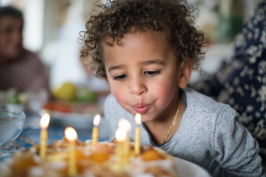 MENA society child blowing candles on homemade birthday cake at family table, authentic home setting, 