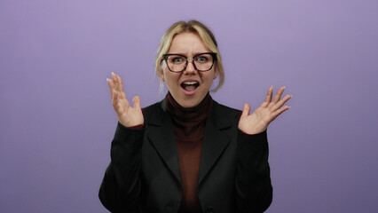 Young blonde woman yelling over an isolated purple background, expressing frustration with open...