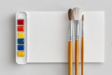 Bright watercolor palette alongside brushes ready for creative e