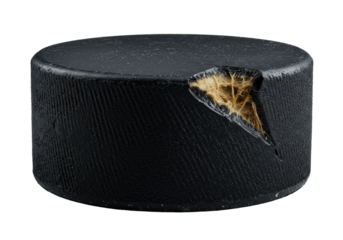 Black rubber ice hockey puck, matte, cross-hatched, sharp gouge, fibrous interior, game-worn, transparent, low-angle macro, studio light, resilience and durability concept.