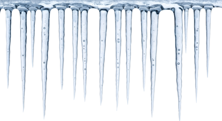 A row of sharp, translucent icicles hanging from a surface, creating a wintery and frozen scene