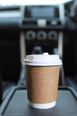 Cup of fresh coffee in the car with the journey