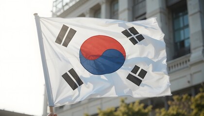 South Korean flag waving proudly in the sunlight against historic building, perfect for travel blogs, news outlets, and cultural exchange programs