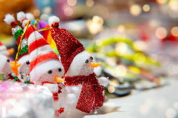 Snowman decorations create a festive atmosphere in a vibrant holiday market during the winter season