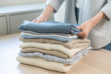 Feel softness, chore of asian young woman, girl housewife hand folding clean clothes after washing,...