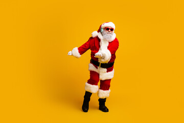 Santa Claus dancing in funky style with sunglass and headphones showcasing festive cheer on a vibrant yellow backdrop