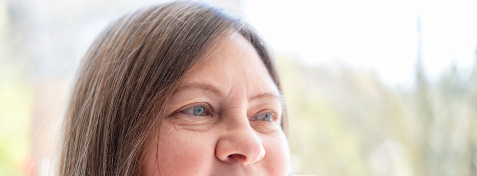 close up part adult female face, mature caucasian woman 50 years, vision examination, cosmetic procedures, drooping eyelid