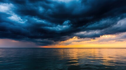 Dramatic sunset over calm ocean waters with dark storm clouds gathering on the horizon