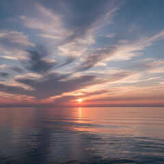 Fototapeta premium A breathtaking sunset over a calm ocean, with a radiant sun reflecting on the water's surface, and the sky filled with dramatic, wispy clouds painted in hues of pink, orange, and blue