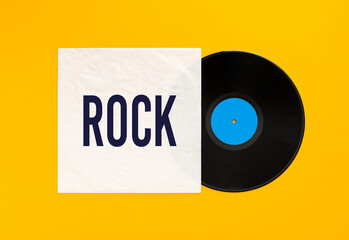 Rock music vinyl record with cover on yellow background