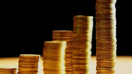 stack of coins and the dollar on a black background, the concept of the ruble's fall Growing stacks of gold coins on black background motion video.