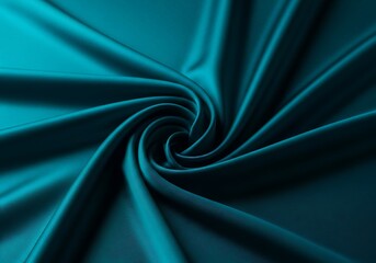 Obraz premium Closeup of a swirling pattern of teal blue satin fabric, showcasing its smooth texture and elegant folds with dramatic lighting