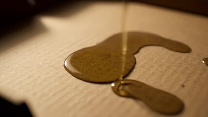 Viscous Golden Brown Extract Dripping Slowly On Parchment Paper. - Powered by Adobe