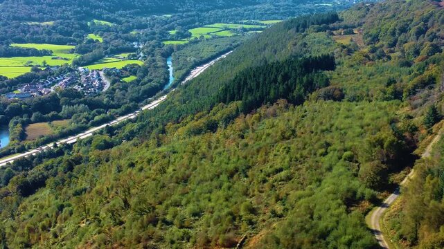 Sideways Aerial with Hiking Gravel Track Adjacent to Busy Welsh Dual Carriageway Road with River Neath and Small Housing Estate. Nature Drone Clip.