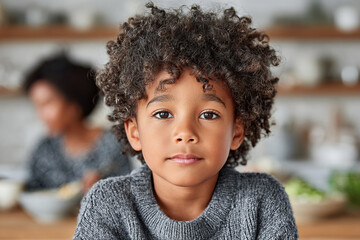 Young boy with curly hair sitting at a dining table, looking directly at the camera, surrounded by healthy food, expressing refusal to eat in a warm home environment