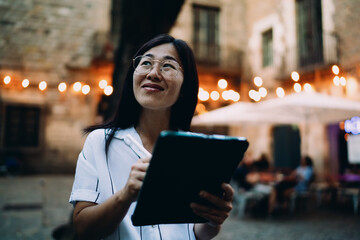 Woman works on digital tablet with pen, immersed in creative concentration, showing portable tech empowerment and intuitive mobile productivity. © BullRun