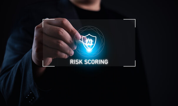 AI security risk scoring concept. Businessman holding digital shield icon with AI chip, showing artificial intelligence in risk evaluation, cybersecurity, and smart decision-making in modern systems.