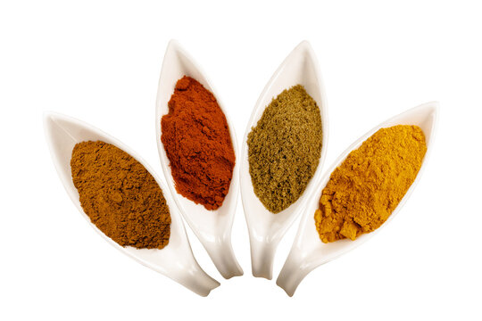 Colorful Asian spices in white ceramic spoons