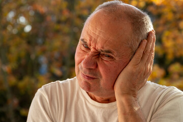 man covering ears with pained expression, Emotional portrait showing discomfort loud noise,...