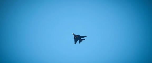 Sleek fighter jet ascends, vapor trails streaking behind, against a clear blue sky,   performance,  aerial
