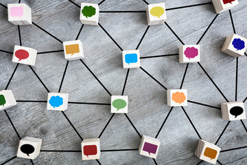 Online messaging, social media, networking, communication and discussion concept wood blocks and speech bubble icons