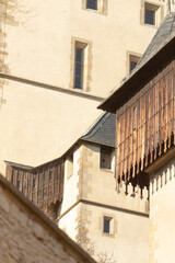 A building styled with a charming wooden balcony gracefully positioned on its side, enhancing its aesthetic appeal and functionality