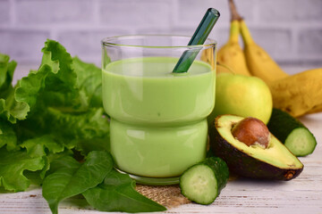 Green smoothie in a glass. Green smoothie made with organic ingredients and vegetables.
