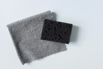 Gray sponge and rag. White background.