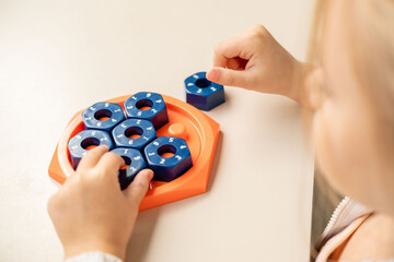 girl solving logic puzzle, Children hands playing with educational math STEM game using pieces learning number composition seven practicing logic thinking fun cognitive activity and math skills