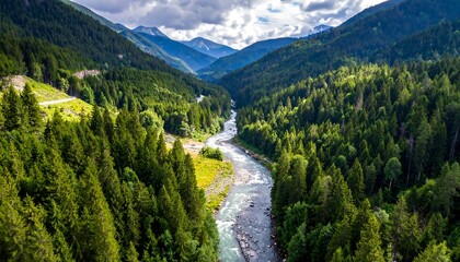 Fototapeta premium Mountain valley with a river winding through lush green forests