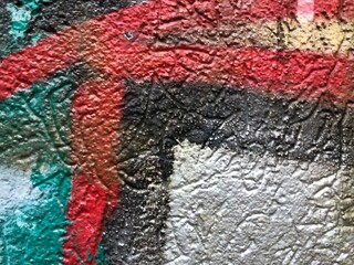 Shiny metallic silver green, red, black  street-art paint graffiti close-up rough texture wallpaper background