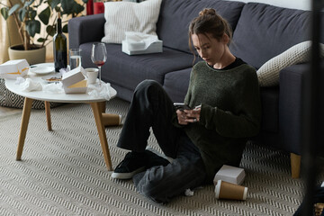 Capturing moments of solitude and reflection in a cozy yet cluttered home environment