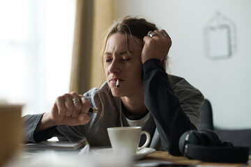 Feeling lost at home, a young woman battles her inner shadows during a quiet moment