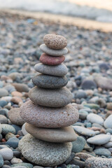 Cairn made of pebbles on the sea shore. Abstract