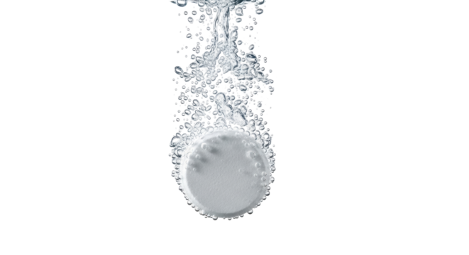 Isolated effervescent tablet dissolving in liquid with bubbles in transparent solution