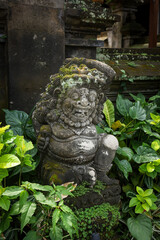 Traditional balinese religious protector stone statue in front of the temple in Ubud, Bali. 