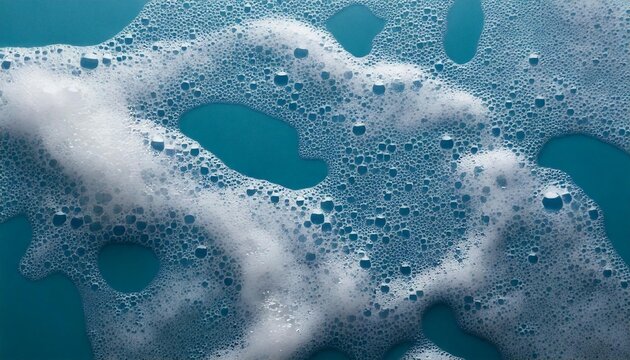 White soap foam texture with bubbles on blue background &mdash; abstract hygiene and skincare concept