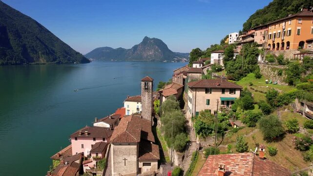 Switzerland Gandria Aerial 4K Video Drone Flight Over Traditional Houses and Church Tower on Lake Lugano.  Scenic Ticino Region Architecture Beautiful Swiss Village Alpine Nature Travel