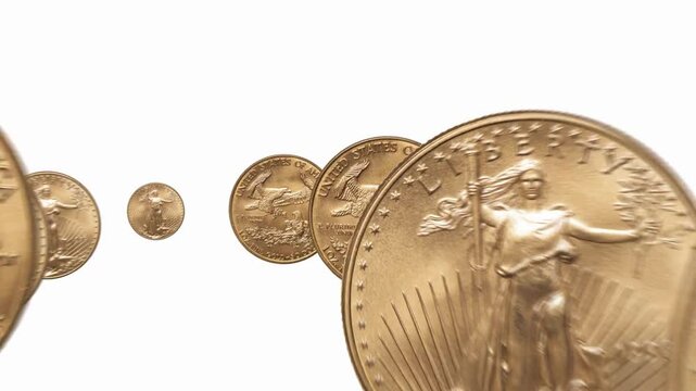 Gold American Eagles coins on a bed of silver coins rotating right background and business or finance saving money
