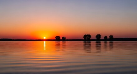 Sunrise over Calm Water with Trees.