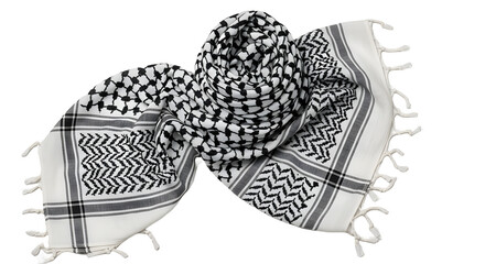 Close-up of a traditionally patterned white and black scarf, neatly folded on a black background.