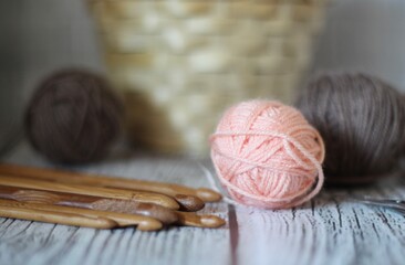 Clews balls of yarn wool and crochet hooks and a basket photo 