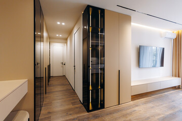 A modern interior corridor features a sleek design along with warm and inviting lighting ambiance