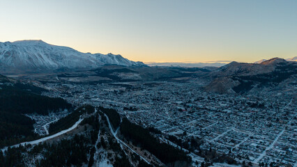 Panoramic aerial cityscape of Esquel at sunrise with snowy mountains in Patagonia Argentina.