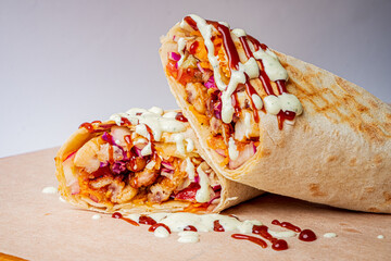 Succulent chicken wrap bursting with flavors, topped with sauces and fresh veggies on display