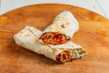 Delicious wraps filled with flavorful meat and crisp vegetables await enjoyment on a sunny day