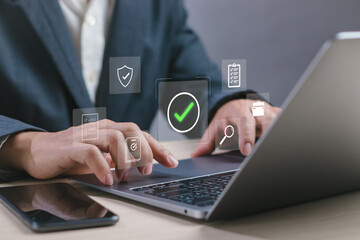 Businessman working on digital document approval with data verification icons on laptop, showing secure workflow system, online audit process and digital business management